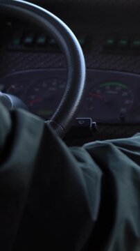 Close-up of old male hands driver steering wheel in a bus, driving passenger. Transport in a communal road vehicle and carrying people, typically serving the public on a route and for a fare.