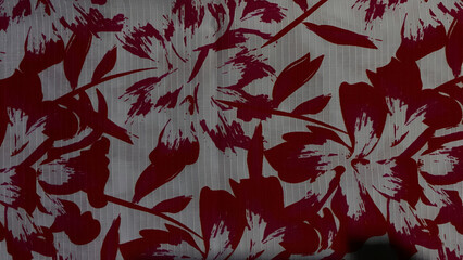 Floral textile with a red and white pattern, featuring a botanical design