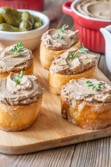 Turkey liver pate on toast with cornichons and cranberry sauce beside