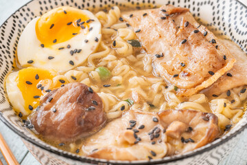 Bowl of ramen with pork belly, soft egg, and shiitake mushrooms