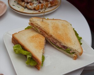 Sandwich with ham, cheese and lettuce on a plate
