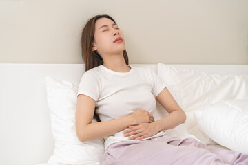 Flatulence ulcer, asian young woman, girl hands in belly, stomach pain from food poisoning,...