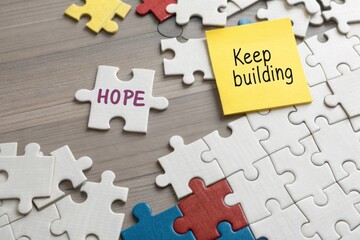 Scattered puzzle pieces representing hope and motivation on desk