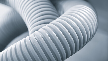 A white tube with a spiral shape. The spiral is made up of many small circles. The tube is white...