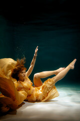 A Graceful Underwater Dance Featuring a Flowing Yellow Dress Surrounded by Vibrant Bubbles
