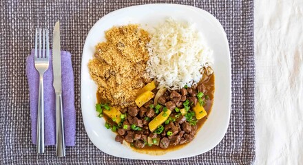 The most traditional Brazilian dish known as picadinho de carne, prepared with cubes of tender, lean beef in a stew with a sauce with typical seasoning and spices, accompanied by white rice and banana