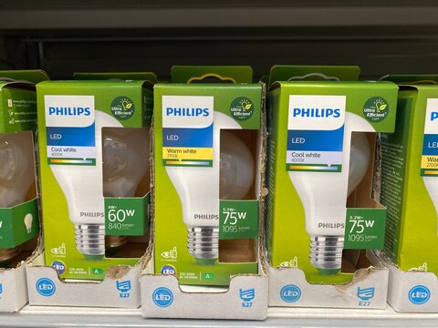 Palma, Spain - October 06, 2025: Philips LED light bulbs displayed on a retail shelf, showcasing various wattages and color temperatures, ideal for energy-efficient lighting solutions