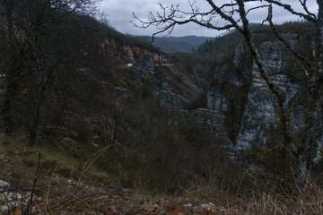 Rocky landscape of the Voidomatis Potamos valley in the Zagoria region at Pindus Mountains on a dark winter day with atmospheric mood, Epirus, Greece