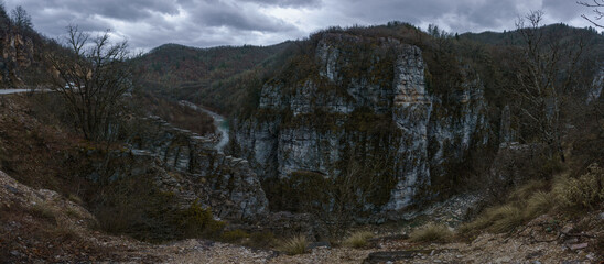 Rocky landscape of the Voidomatis Potamos valley in the Zagoria region at Pindus Mountains on a dark winter day with atmospheric mood, Epirus, Greece