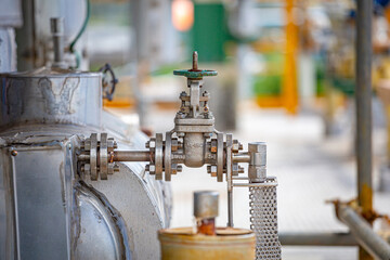 A globe hand-operated valve installed in a chemical plant pipe allows manual control of flow, demonstrating precision, safety,