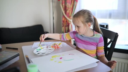 girl painting with watercolors at home - Powered by Adobe