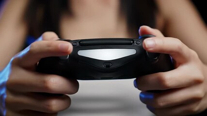 Extreme close-up video of precise human hands manipulating a matte black wireless game controller with white light bar and electric blue glow in a dark nocturnal setting, high-performance gaming - Powered by Adobe