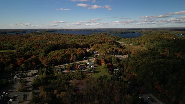 Aerial above Port Carling small town in Ontario Canada on sunny fall day