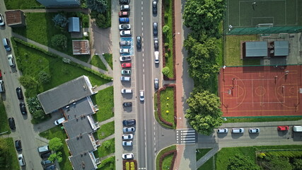 Aerial view of urban street with parking Lot, basketball court, and residential Buildings