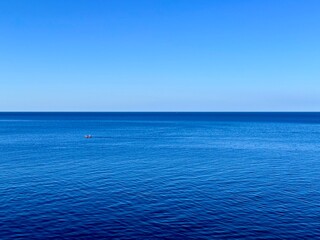 fantastic blue seascape, rocky sea coast, blue sea and blue sky