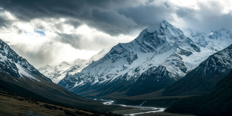 Majestic Snow-Capped Mountains Under Dramatic Cloudy Sky
