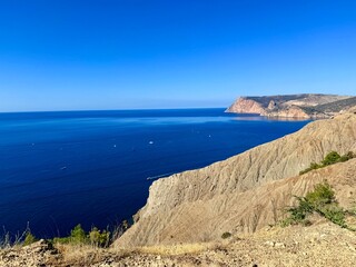 fantastic blue seascape, rocky sea coast, blue sea and blue sky
