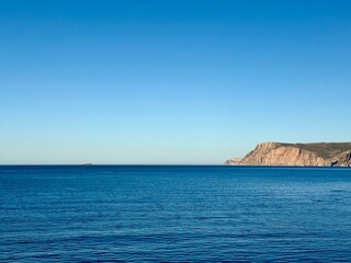 fantastic blue seascape, rocky sea coast, blue sea and blue sky
