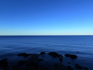fantastic blue seascape, rocky sea coast, blue sea and blue sky