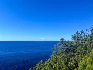 fantastic blue seascape, rocky sea coast, blue sea and blue sky