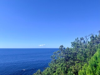 fantastic blue seascape, rocky sea coast, blue sea and blue sky