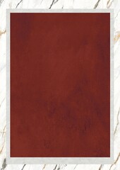 A textured maroon surface framed by a white border on a marble background