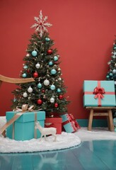 Blue gift boxes with orange ribbons and Christmas tree on red background, festive holiday decoration scene.