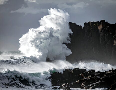 Powerful ocean waves crashing against a rocky coastline - Powered by Adobe