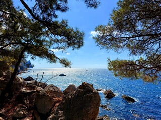 fantastic blue seascape, rocky sea coast, blue sea and blue sky