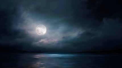 Fototapeta premium A bright full moon glows through atmospheric clouds casting ethereal light upon a dark reflective lake surface at night