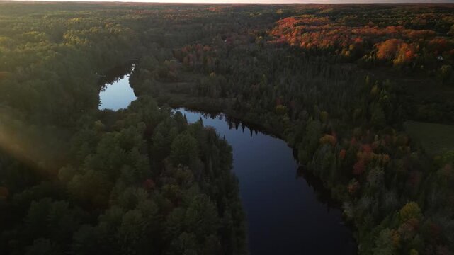 Aerial of Muskoka River at sunset with glassy water in Ontario Canada