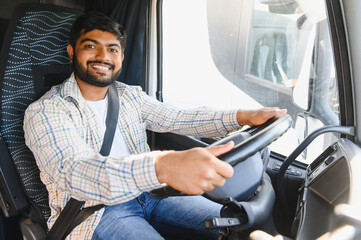 Smiling young male truck driver operating vehicle