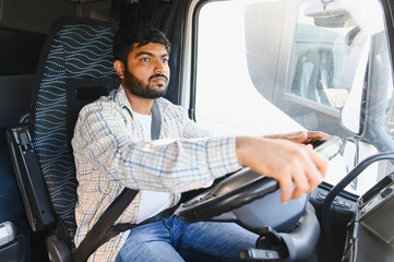 Indian man driving truck, focused on the road journey