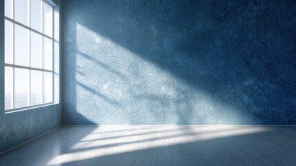 Obraz premium Empty room with large window and sunlight casting shadows on blue wall and wooden floor. Modern interior design for decoration.