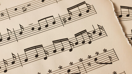 Fototapeta premium Closeup of musical notes on aged sheet music paper