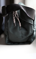 Light-colored zipper pulls on a dark blue bag