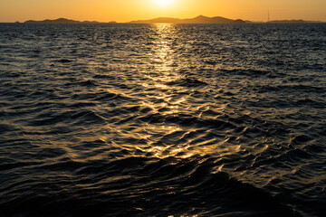 Obraz premium idyllic seascape with sunlight reflections on the sea during sunset