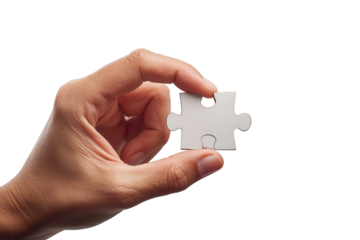 Close-up of a hand holding a single jigsaw puzzle piece against a transparent background, symbolizing challenge