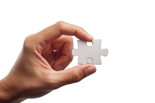 Close-up of a hand holding a single jigsaw puzzle piece against a transparent background, symbolizing challenge