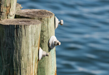 Large metal nut and bolt fixing in a heavy wooden post.