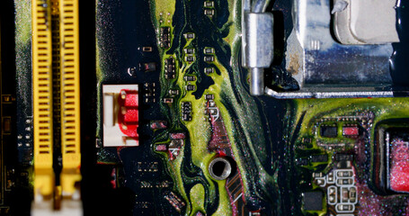 Acrylic ink. Circuit board. Blur yellow purple red colorful glitter liquid microchip dark black water on abstract electronic background.