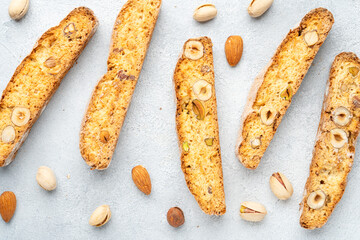 Biscotti, traditional italian bakery with nuts mix. Top view on white.