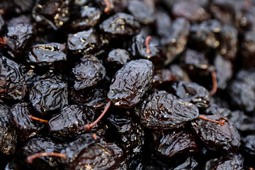 Closeup of a dried an smoked plum presented at a an agricultural products fair.