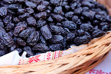 Closeup of a dried an smoked plum presented at a an agricultural products fair.