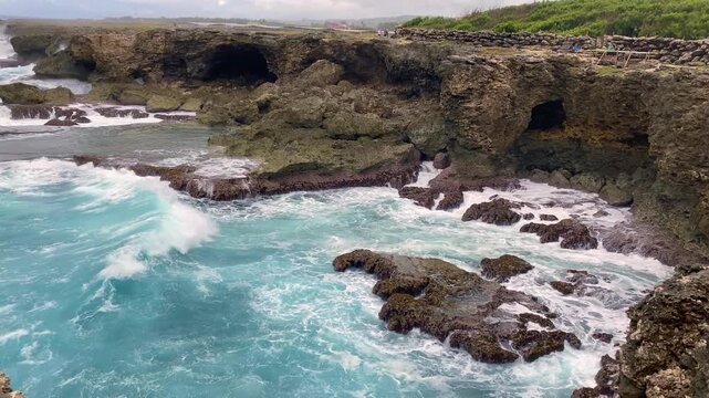 Animal Flower Cave and cliffs at North Point, St. Lucy, Barbados. Cave and cliffs with a coral floor that opens directly into Atlantic Ocean. Waves beating into the rock. 
