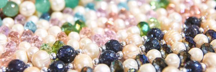 Close-up of colorful pearl and gemstone beads in various shapes and sizes.