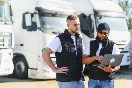 Fototapeta Truck drivers using laptop managing logistics fleet