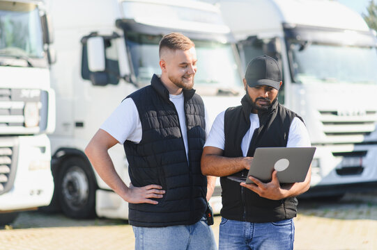 Two men managing logistics with truck fleet - Powered by Adobe