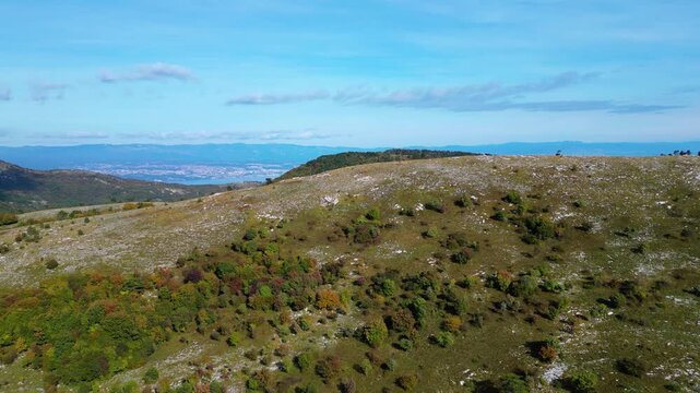 Aerial view of Mount Učka (Ucka) ridge with Vojak peak, winding mountain road, and autumn landscape near Brgud and Mala Učka, Istria, Croatia. Scenic panorama of Učka Nature Park