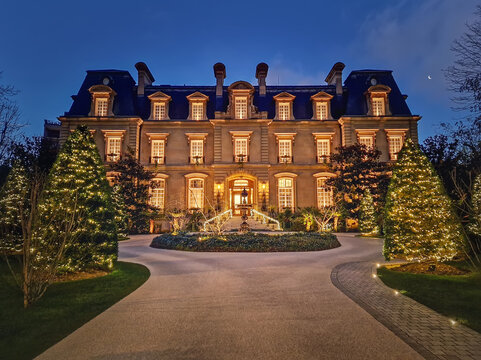 Paris, France - December 26, 2024 Beautiful nighttime view of the Saint James Hotel, a grand neoclassical chateau. The elegant mansion is framed by Christmas trees decorated with festive holiday light